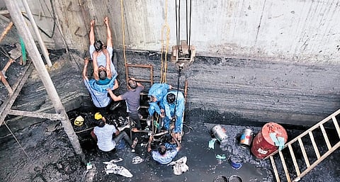 Co-workers rescuing workers who collapsed while cleaning a waste storage tank at United Industries Plastic Private Limited near Sriperumbudur on Tuesday.