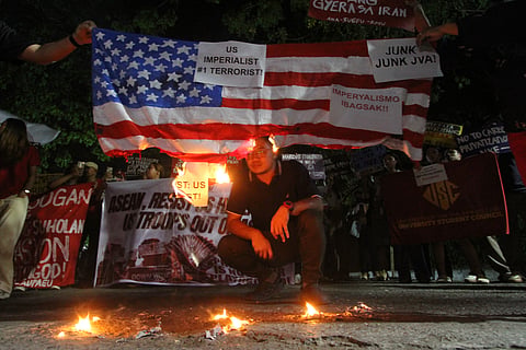 Protesters burn a mock US flag to condemn the war in Iran as they hold a rally that coincides with the 48th ASEAN Summit and Related Meetings in Cebu, central Philippines on Friday May, 8, 2026. 