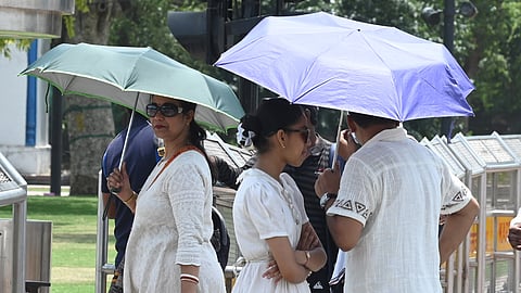 People seen out on a hot day at India Gate, on May 19, 2026 in New Delhi.