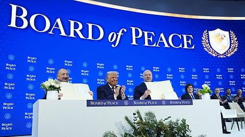FILE - President Donald Trump, center, applauds as Ilham Aliyev, President of Azerbaijan, left, and Bulgaria's Prime Minister Rossen Jeliazkov, right, hold up their signed Board of Peace charter during the Annual Meeting of the World Economic Forum in Davos, Switzerland, Jan. 22, 2026.