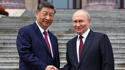 Russian President Vladimir Putin, right, and Chinese President Xi Jinping shake hands during a welcome ceremony at the Great Hall of the People, in Beijing, China, on Wednesday, May 20, 2026. 