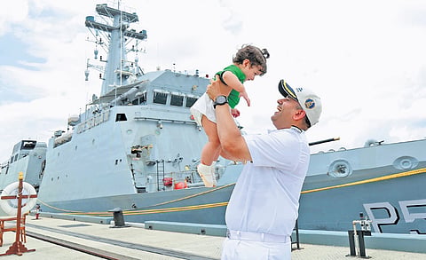 Commander Sidharth Chaudhary, Commanding Officer of INS Sunayna, with his one-year-old daughter Samaira, who he met after his two-month-long deployment, at Kochi Naval Base on Wednesday 