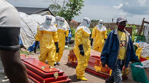 Red Cross workers arrive at a health center to transport people who died of Ebola in Rwampara, Congo, Wednesday, May 20, 2026. 