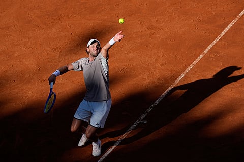 Casper Ruud, of Norway, serves to Jannik Sinner, of Italy, during the final match at the Italian Open tennis tournament