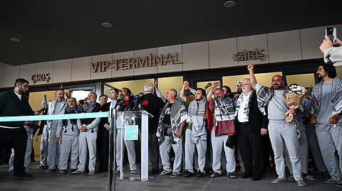 Members of the Global Sumud Flotilla headed for Gaza and arrested and deported by Israel pose outside a terminal following their arrival at Istanbul Airport on May 21, 2026.