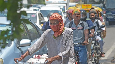 People use scarves to cover their faces for protection from the sun on Wednesday.