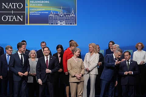 United States Secretary of State Marco Rubio, front second left, and NATO Secretary General Mark Rutte, front left, speak with each other during a group photo at a meeting of NATO foreign ministers in Helsingborg, Sweden, Friday, May 22, 2026.