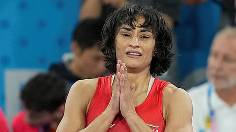 India's Vinesh Phogat celebrates after winning her women's freestyle 50 kg semi-final wrestling match against Cuba's Yusneylys Guzman Lopez at the 2024 Summer Olympics in Paris.