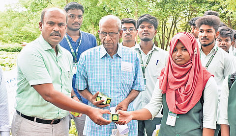 Gregory distributing seed balls to school children at the forest office at MR Palayam division in Tiruchy 