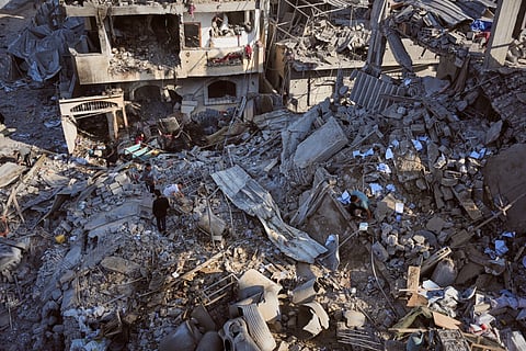 Palestinians inspect the rubble of the Al-Kurd family home, destroyed in an Israeli airstrike in Deir al-Balah, central Gaza Strip, Sunday, May 24, 2026. 