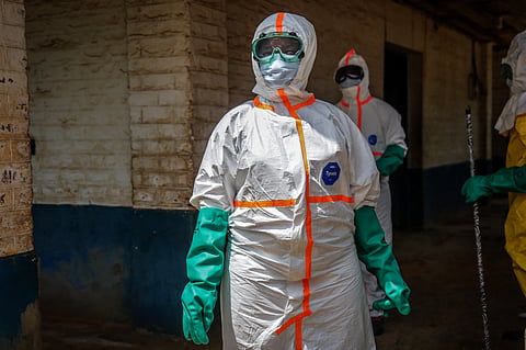 Health workers wearing protective equipment gather to disinfect the isolation area for Ebola patients at the General Referral Hospital of Mongbwalu in Mongbwalu, on May 23, 2026