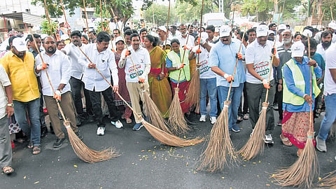 MA&UD Minister P Narayana, along with MA&UD Principal Secretary S Suresh Kumar and other dignitaries, cleans the road in Vijayawada on Saturday 