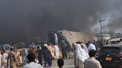 Paramilitary soldiers and volunteers recover victims from an overturned train coach on a railway track at the site of bomb explosion, in Quetta, Pakistan, Sunday, May 24, 2026. 
