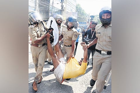Policemen take a KSU worker to the van during the DGP office march taken out against police atrocities on its activists during the Nava Kerala Sadas.