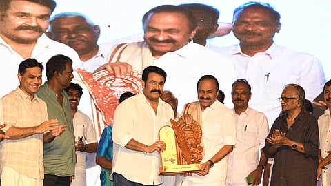 Actor Mohanlal honours chief minister V D Satheesan with a shawl during the reception in Paravur.
