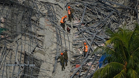 A K9 joins rescuers as they continue search operations at a collapsed building where multiple people are believed to be trapped in Angeles city in Pampanga province, north of Manila Monday, May 25, 2026. 