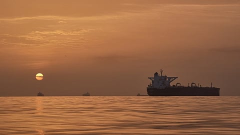 The sun rises behind tankers anchored in the Strait of Hormuz off the coast of Qeshm Island, Iran, Saturday, April 18, 2026. 
