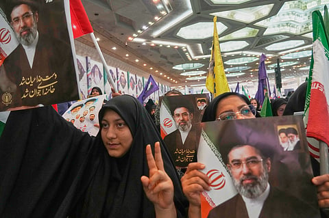 Women hold portraits of Iran's Supreme Leader, Ayatollah Mojtaba Khamenei, during a ceremony honoring the armed forces and those killed in the war with Israel and the U.S. at the Imam Khomeini Grand Mosque in Tehran, Iran, Sunday, May 24, 2026. 