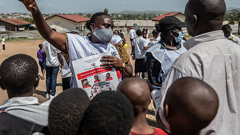 Vanny Birungi, a Red Cross volunteer, speaks to people during a public sensitisation campaign amid the Ebola outbreak in Bunia, Congo, Monday, May 25, 2026