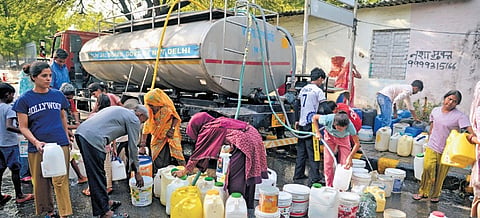 People wait in a queue to fill water in Chanakyapuri on Wednesday 