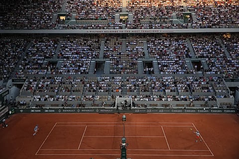 Clement Tabur of France, right, returns to Jannik Sinner of Italy during their first round men’s singles tennis match at the French Open tennis tournament in Paris, Tuesday, May 26, 2026. 