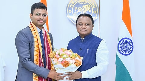 Chief Minister Mohan Charan Majhi felicitating OCS topper Bubun Sahoo at Lok Seva Bhawan.