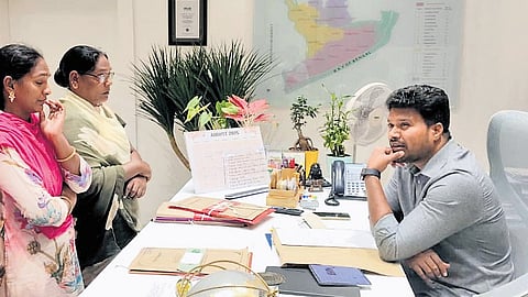 Konaseema Centre for Migration Coordinator Golla Ramesh interacting with the kin of a migrant.
