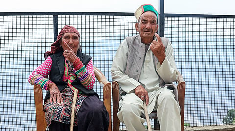An elderly couple show their ink-marked fingers after casting their votes during the second phase of the Himachal Pradesh Panchayat polls, in Mandi on Thursday.