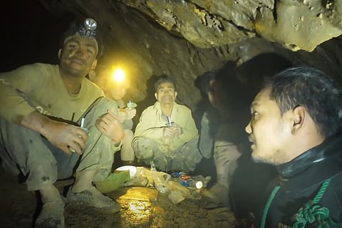 This image made from the video provided by Benz Norrased Palasing Seascout Diving shows rescuers speaking to the villagers who were trapped and found in a flooded cave in Xaisomboun province, Laos, Wednesday, May 27, 2026.