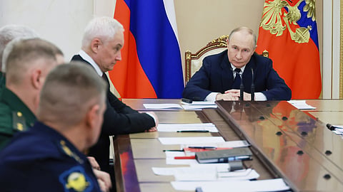 Russian President Vladimir Putin, right, attends a meeting with senior military officers as Russian Defense Minister Andrei Belousov, fourth left, sits near at the Kremlin in Moscow, Russia, Dec. 29, 2025.
