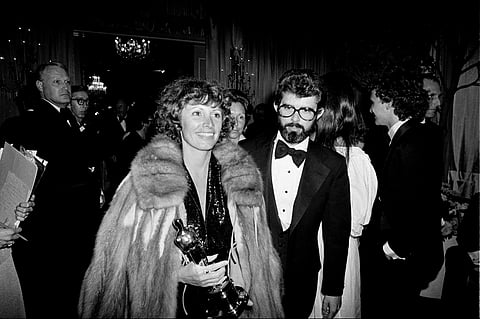 Marcia Lucas, wife of director George Lucas, right, carries her Oscar statuette as they arrive at a post Academy Awards party at the Beverly Hilton Hotel in Los Angeles, April 4, 1978.