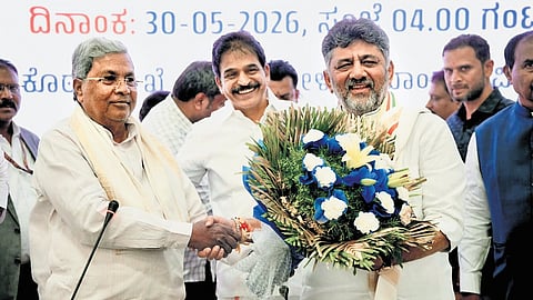 Caretaker Chief Minister Siddaramaiah greets CM-in-waiting DK Shivakumar after the Congress Legislature Party meeting at Vidhana Soudha in Bengaluru on Saturday.