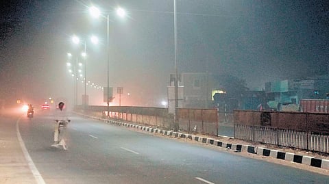 Dust from stone quarries reduces visibility on a road in Athmakur mandal