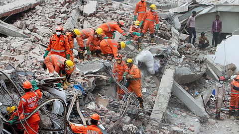 NDRF and police conduct a rescue operation after a three-storey commercial building collapsed on Saturday evening near the Saket Metro station,