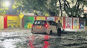A car submerged in a waterlogged road near Collector Office Chowk after the storm.