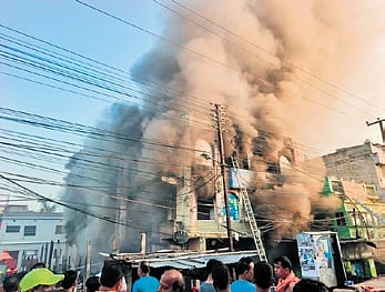 The G+2 building in flames after fire erupted in the adjacent fish market