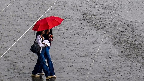 People cover themselves as they walk amid rainfall, in Shimla, Himachal Pradesh, Monday, June 1, 2026. 