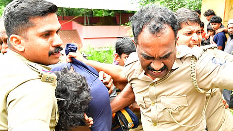 Police bring Ashkar, who is alleged to be the accused in the murder of a one-and-a-half-year-old child at Panavoor near Nedumangad in Thiruvananthapuram, to the scene of the incident for evidence collection on Sunday.