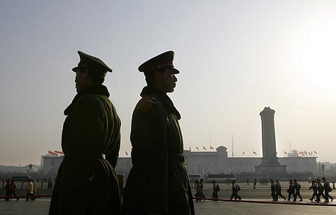 Paramilitary soldiers stand guard in front of Great Hall of the People overlooking Tiananmen Square,