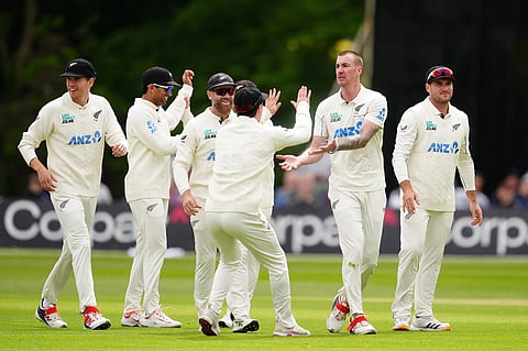 New Zealand's Blair Tickner, second right, and teammates celebrate after Ireland's Harry Tector was caught out by Tom Latham on day three of the test match in Belfast, Northern Ireland, Friday, May 29, 2026.