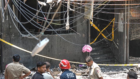 Police and firefighters at the site after a fire broke out at a bed-and-breakfast in a five-storey building in south Delhi's Malviya Nagar area, Wednesday, June 3, 2026.