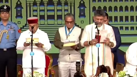 Congress Legislature Party leader DK Shivakumar (R) takes oath as Karnataka Chief Minister as Governor Thaawarchand Gehlot administers the oath at Lok Bhavan in Bengaluru on Wednesday.