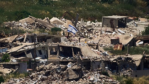 An Israeli flag hangs on a destroyed building in southern Lebanon as seen from northern Israel, Thursday June 4, 2026. 