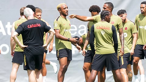 Canada defender Derek Cornelius, center, warms up during the selection camp for Canada's national soccer team, Thursday, May 28, 2026, in Charlotte, N.C., ahead of the FIFA World Cup soccer tournament.