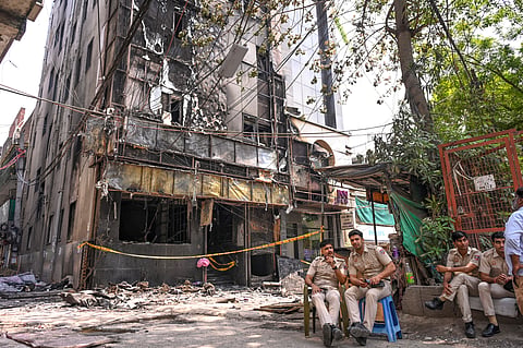  Police and firefighters at the site after a fire broke out at a bed-and-breakfast in a five-storey building in south Delhi's Malviya Nagar area, Wednesday, June 3, 2026. 
