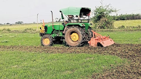A farmer ploughs his field using a tractor in Hanamkonda district on Wednesday