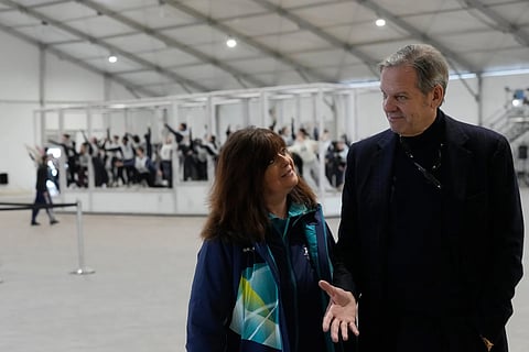 Creative Director and Executive Producer Marco Balich speaks with director of ceremonies Maria Laura Iascone as volunteer dancers perform during rehearsals for the opening ceremony of the Milan Cortina 2026 Winter Olympics Games, at a compound in a big tent next to San Siro Stadium, in Milan, Italy, Saturday, Jan 24, 2026.