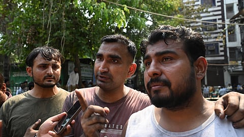 Local residents rescue people from a building and shift them to nearby hospitals after a massive fire broke out at a bed-and-breakfast Restaurant and Hotel in the Malviya Nagar.