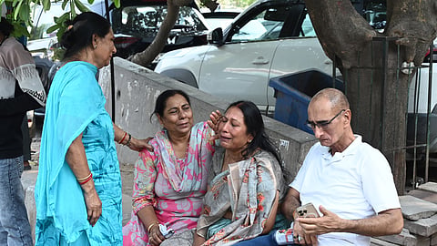 Family members stand outside MAX hospital after fire incident in Malviya Nagar area leaves 21 people dead, in New Delhi, Wednesday, June 3, 2026.