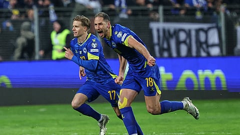 Bosnia's Nikola Katic, right, and Bosnia's Dzenis Burnic celebrate after winning a penalty shootout during the World Cup qualifying playoff final soccer match between Bosnia and Italy in Zenica, Bosnia, on March 31, 2026.